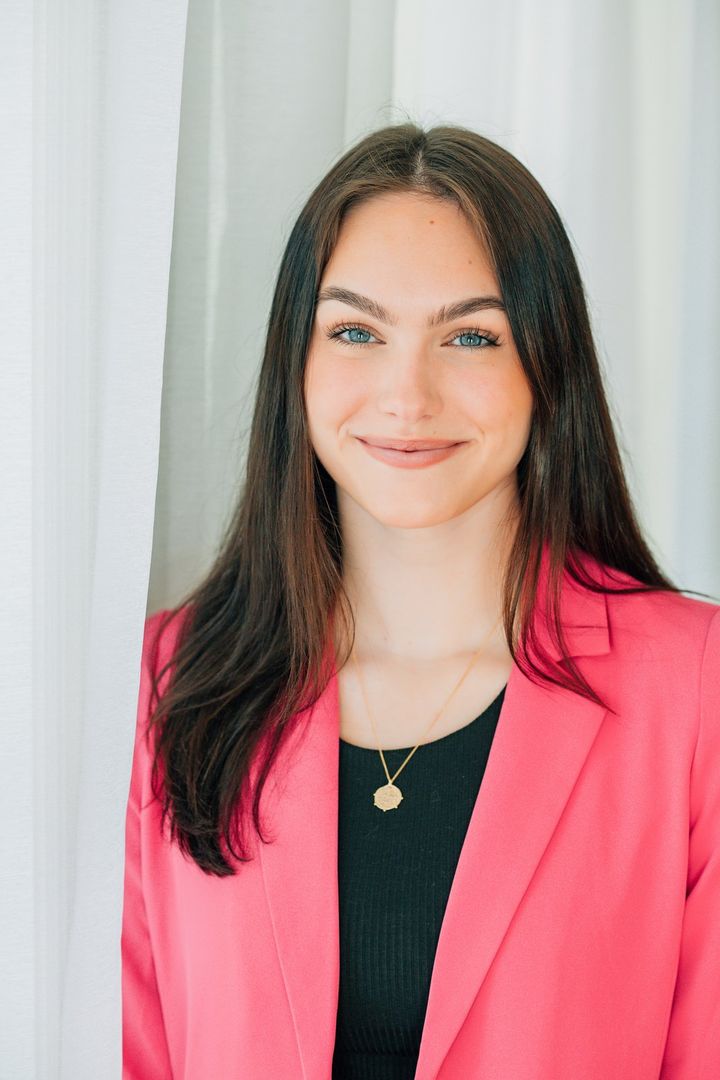 Sydney Mason headshot in a pink blazer